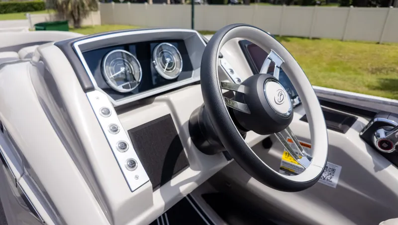 Slide: The Image of The image shows the helm of a 2025 Barletta Corsa 23M boat. - 30