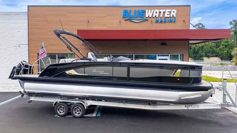 Slide: The Image of 2025 Barletta LUSSO 25U on a trailer in front of a building labeled "Blue Water Marine." - 29