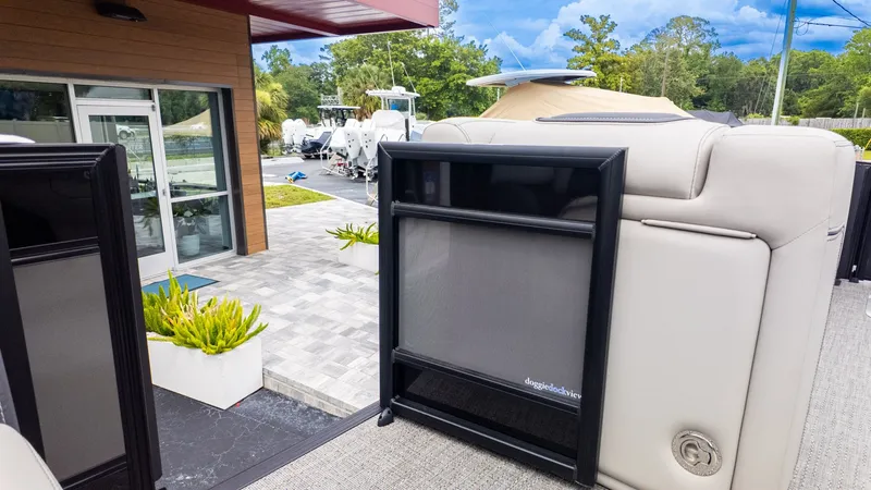 Slide: The Image of The image shows the rear of a 2025 Barletta LUSSO 25U boat docked at a marina. - 12