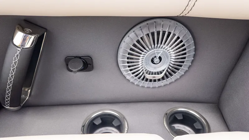 Slide: The Image of Close-up of a speaker and cup holders in a Barletta LUSSO 25U boat. - 16