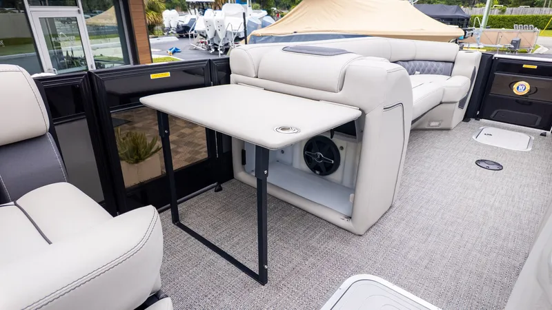 Slide: The Image of Interior of a Barletta LUSSO 25U with beige seating and a foldable table. - 13