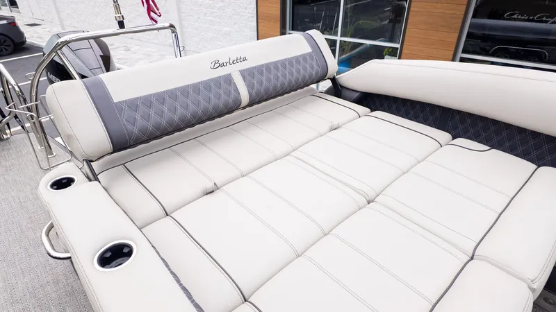Slide: The Image of The image shows the luxurious sun deck of a 2025 Barletta LUSSO 25U with comfortable cushions. - 6