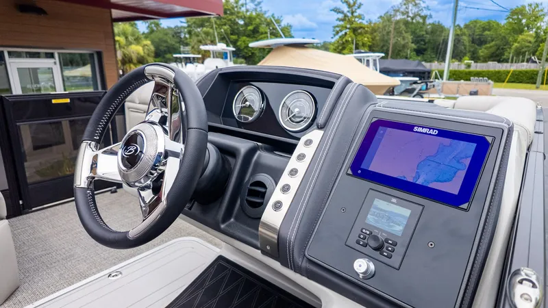 Slide: The Image of The image shows the helm of a 2025 Barletta LUSSO 25U boat. - 24