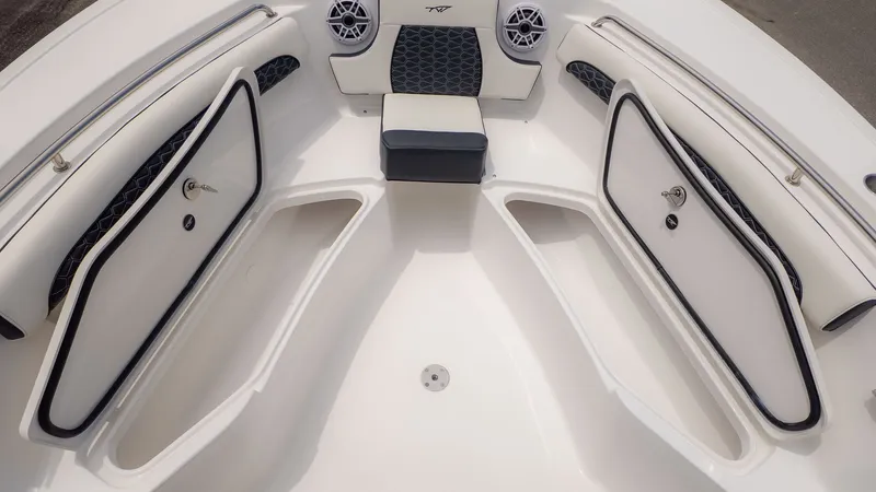 Slide: The Image of The image shows the bow area of a Tidewater 232 LXF boat with cushioned seats and speakers. - 13