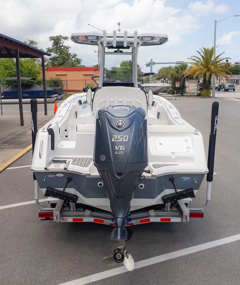 Slide: The Image of Rear view of a Tidewater 232 LXF boat with a 250 HP V6 outboard motor, parked on a trailer. - 3