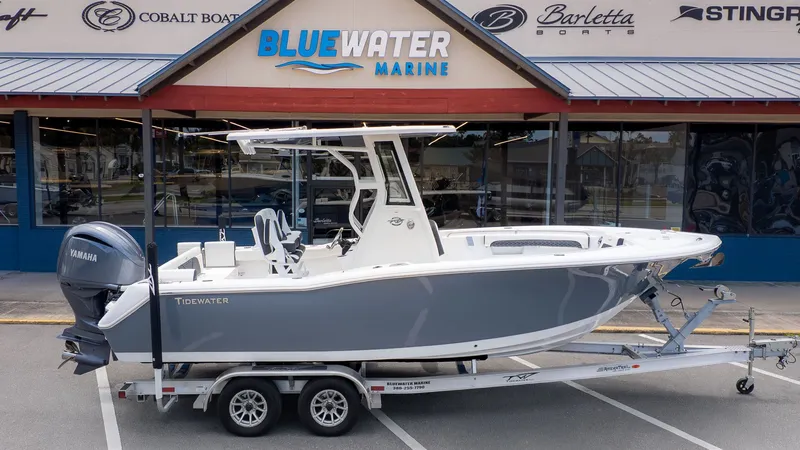 Slide: The Image of Tidewater 232 LXF from 2027 parked on a trailer in front of a boat dealership. - 20