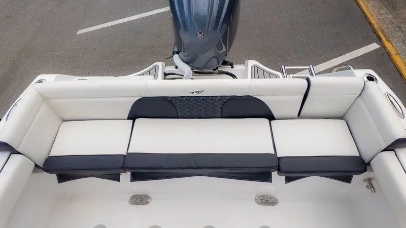 Slide: The Image of The image shows the stern of a Tidewater 232 LXF boat with white upholstery. - 6