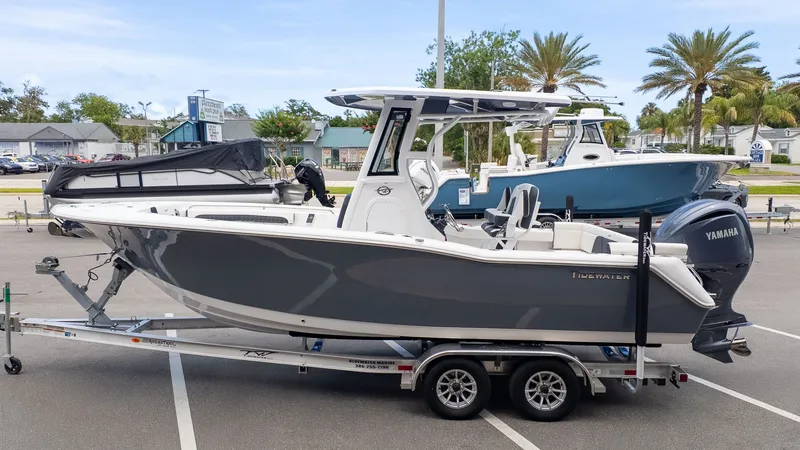 Slide: The Image of A gray Tidewater 232 LXF boat from 2027 is on a trailer in a parking lot. - 21