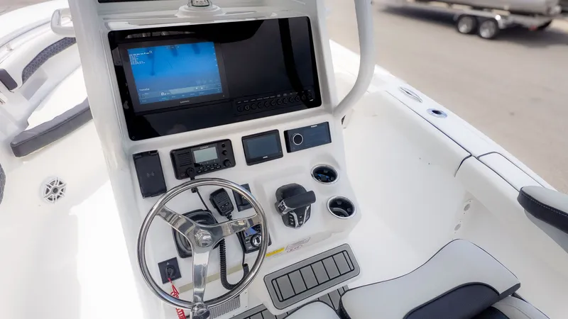 Slide: The Image of The image shows the helm of a 2027 Tidewater 232 LXF boat with modern instruments. - 16