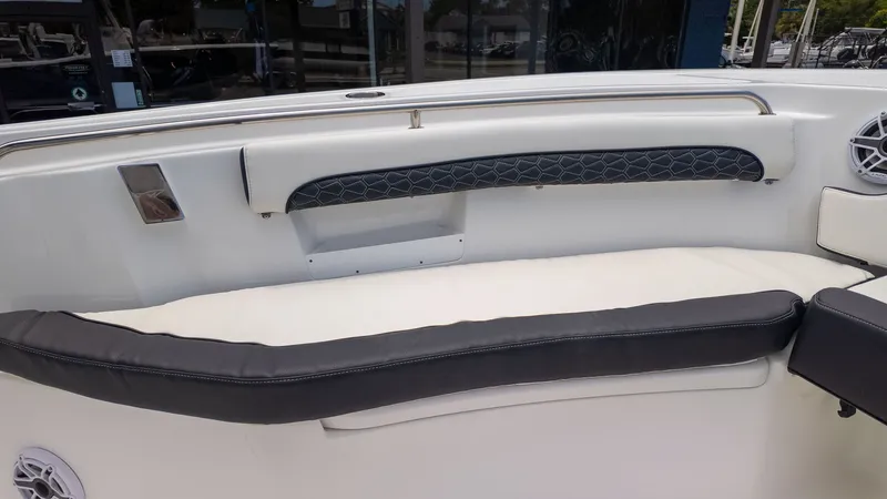 Slide: The Image of The boat's seating area features white and black cushions with speakers on the sides. - 10