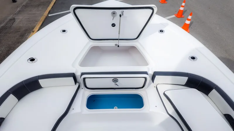 Slide: The Image of The image shows the deck of a Tidewater 2300 Carolina Bay boat with storage and seating. - 19