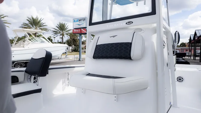 Slide: The Image of Tidewater 2300 Carolina Bay 2026 with white seating and black cushion, parked outdoors. - 23