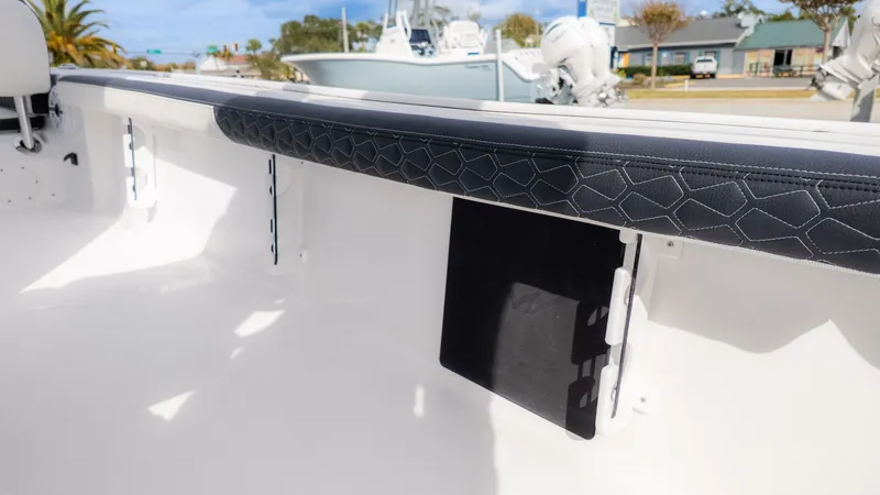 Slide: The Image of Interior view of a Tidewater 2300 Carolina Bay boat with padded seating and storage space. - 8