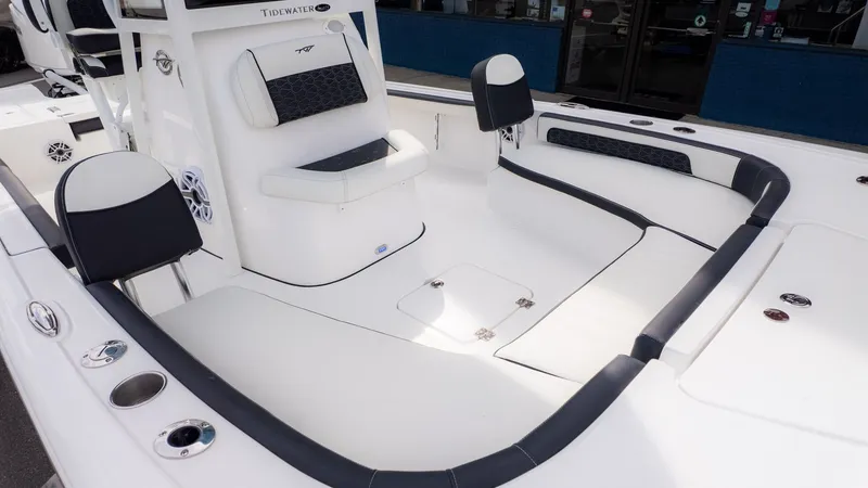 Slide: The Image of The image shows the spacious deck of a Tidewater 2300 Carolina Bay boat with white and black seating. - 21