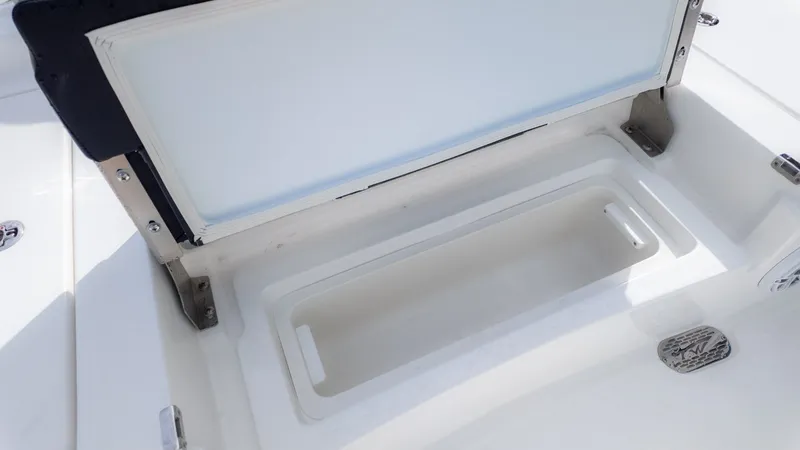 Slide: The Image of An open storage compartment on a boat with white surfaces and metal fittings. - 7