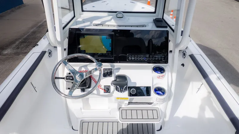 Slide: The Image of The image shows the helm of a Tidewater 2300 Carolina Bay boat with modern instruments. - 13