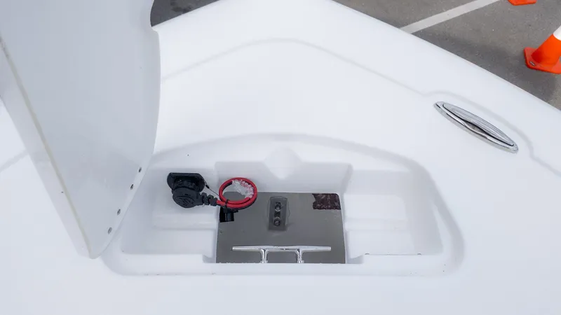 Slide: The Image of An open storage compartment on a boat with a red ring and metal latch. - 19