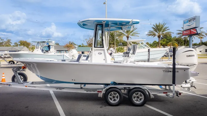 The Image of A 2026 Tidewater 2300 Carolina Bay boat on a trailer in a parking lot. - 1