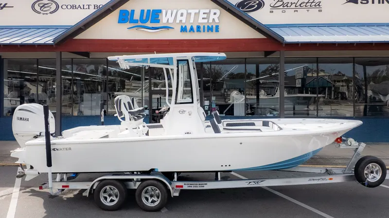 Slide: The Image of Tidewater 2300 Carolina Bay 2026 on a trailer in front of a boat dealership. - 24