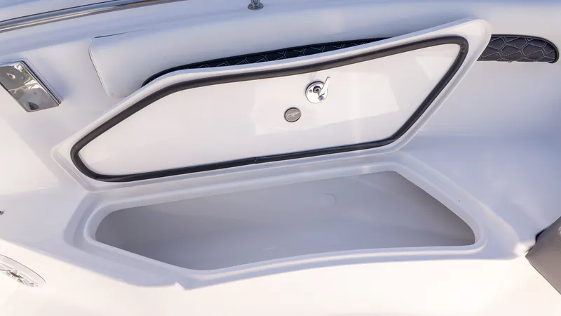 Slide: The Image of An open storage compartment on a boat with a lid and a latch. - 20