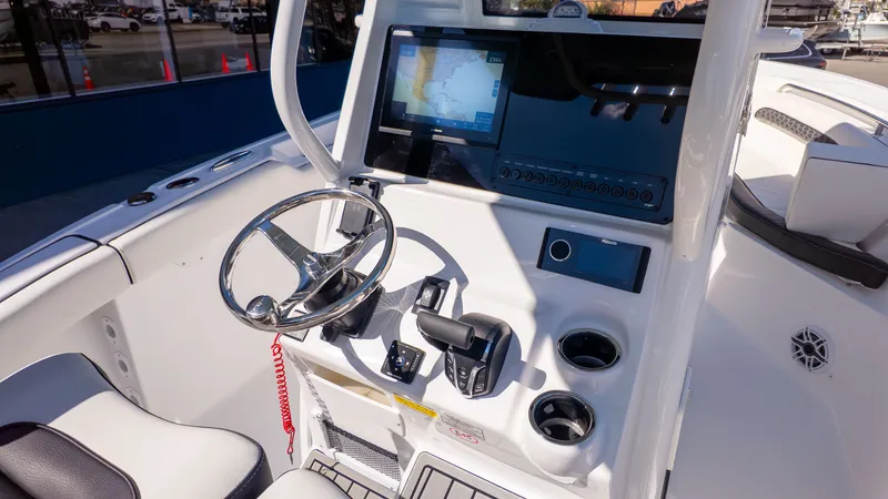 Slide: The Image of The image shows the helm of a Tidewater 232 LXF boat with modern controls and a large screen. - 10
