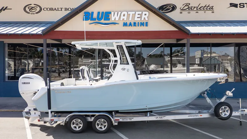 Slide: The Image of Tidewater 232 LXF on a trailer in front of a boat dealership. - 23