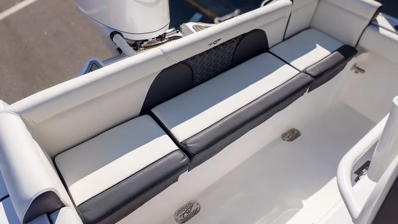 Slide: The Image of Seating area on a Tidewater 232 LXF boat, featuring cushioned white and black seats. - 7
