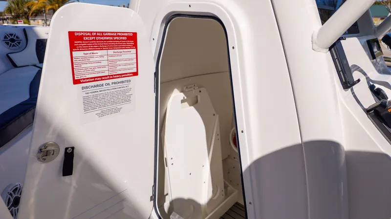 Slide: The Image of The cabin of a Tidewater 232 LXF boat with an open door and warning notices. - 21
