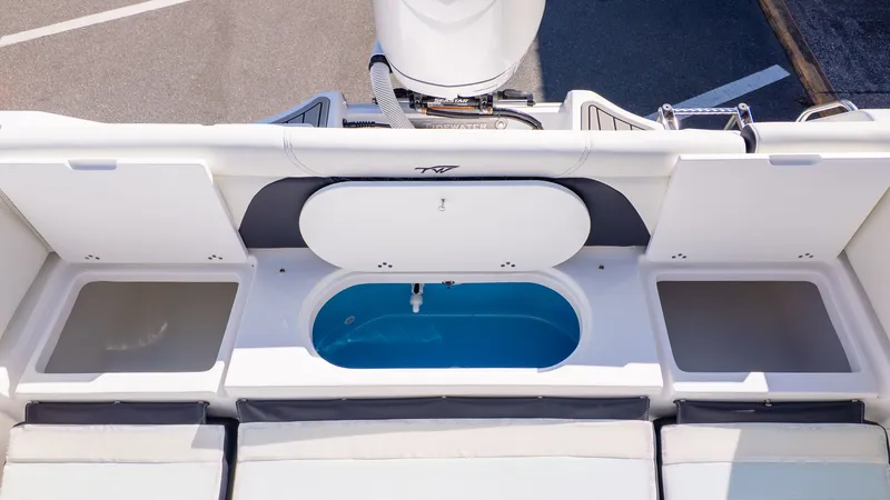 Slide: The Image of The image shows the stern of a Tidewater 232 LXF boat with a livewell and storage. - 8