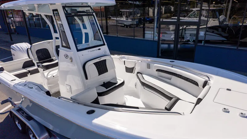 Slide: The Image of The image shows a modern boat with a white hull and black interior, sitting on a trailer. - 13