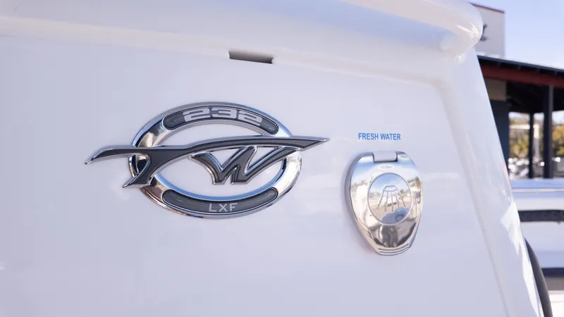 Slide: The Image of Close-up of the logo and fresh water hatch on a Tidewater 232 LXF boat. - 12