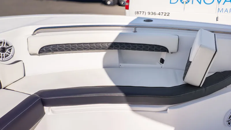 Slide: The Image of The image shows a boat's seating area with cushioned seats and speakers. - 18