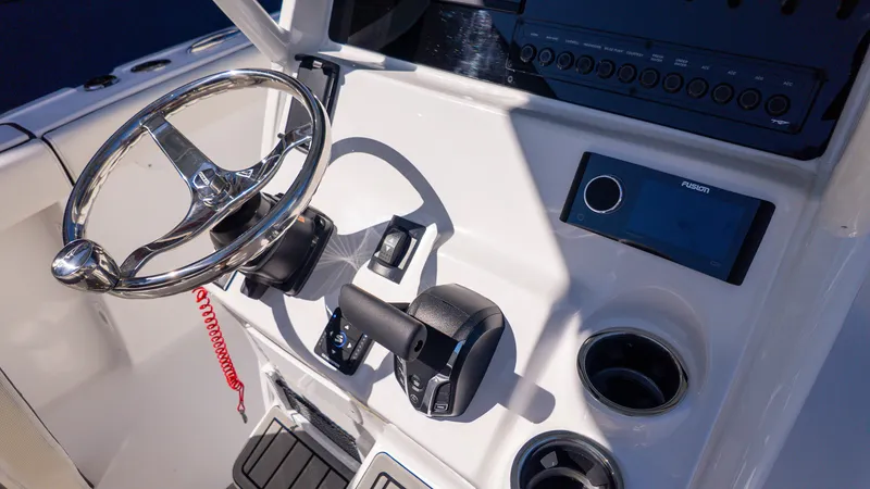 Slide: The Image of The image shows a boat's helm with a shiny steering wheel and modern controls. - 9