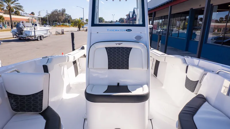Slide: The Image of The image shows the interior of a 2026 Tidewater 232 LXF boat with white and black seating. - 14