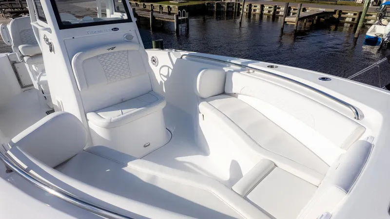 Slide: The Image of The image shows the cockpit of a Tidewater 232 CC Adventure boat with white upholstery. - 18