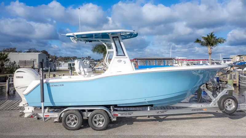 Slide: The Image of A light blue Tidewater 232 CC Adventure boat on a trailer, ready for launch. - 24