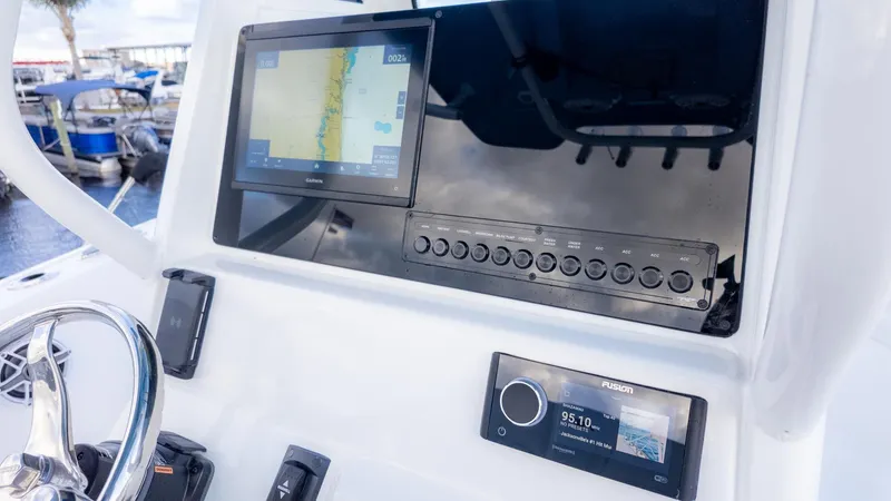 Slide: The Image of The image shows the dashboard of a Tidewater 232 CC Adventure boat with modern navigation equipment. - 14