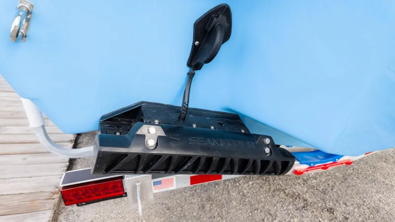 Slide: The Image of Close-up of a boat part with a black device on the blue hull. - 4
