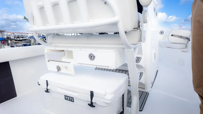Slide: The Image of The image shows the cockpit of a Tidewater 232 CC Adventure boat with storage and a cooler. - 7