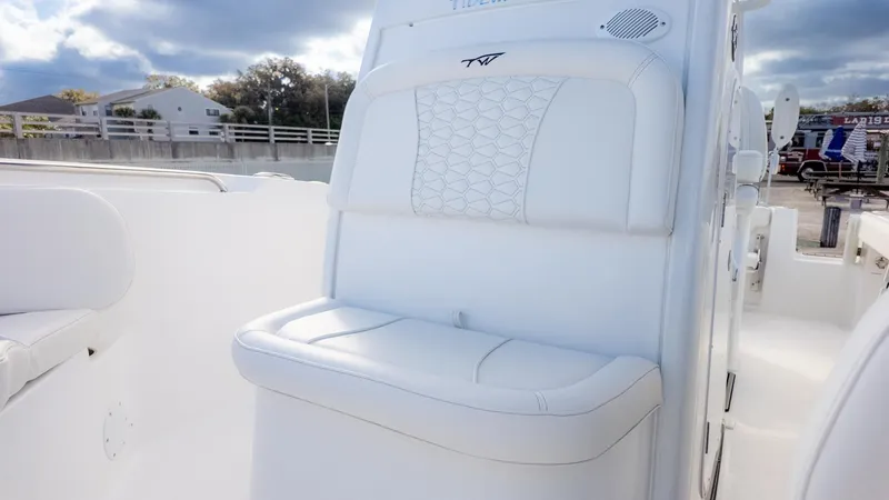 Slide: The Image of The image shows a white seat on a 2026 Tidewater 232 CC Adventure boat. - 20