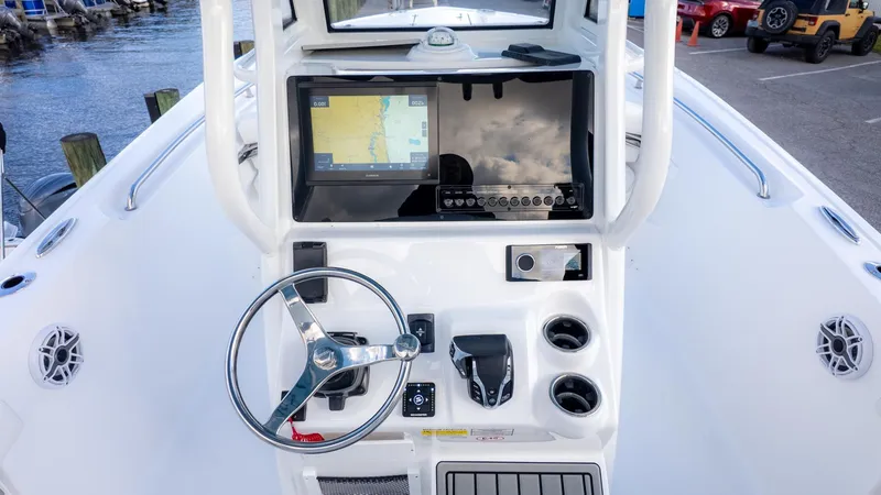 Slide: The Image of The image shows the helm of a Tidewater 232 CC Adventure boat with modern navigation equipment. - 11