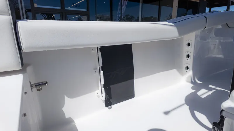 Slide: The Image of Interior view of a white boat with padded seating and rod holders. - 8