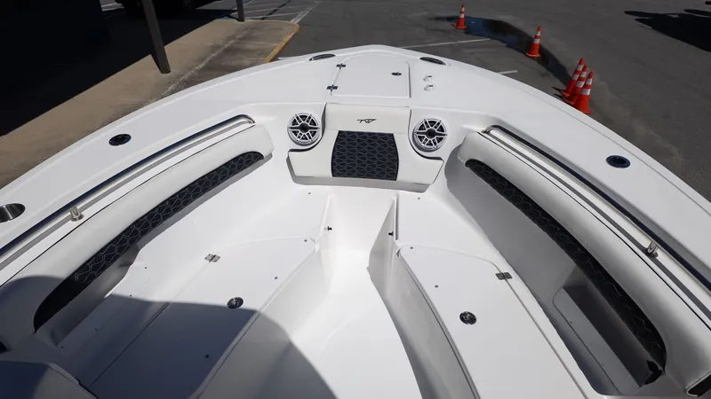 Slide: The Image of The image shows the bow of a Tidewater 232 LXF boat with white seating and speakers. - 13
