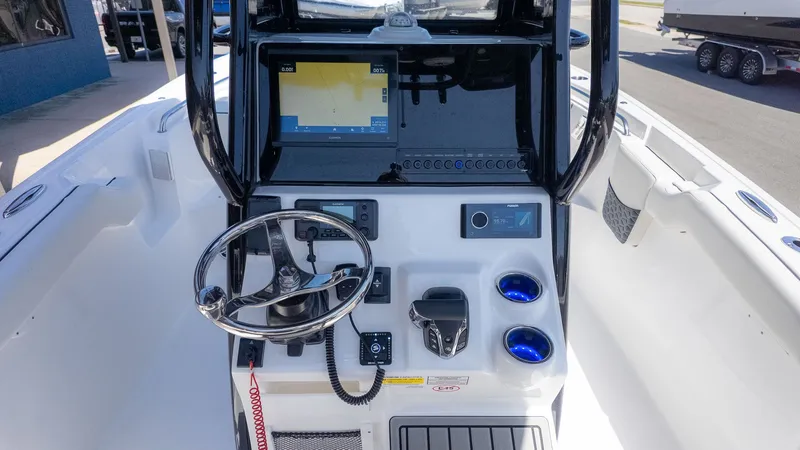 Slide: The Image of The image shows the helm of a Tidewater 232 LXF boat with modern instruments and a screen. - 19