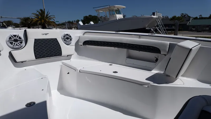 Slide: The Image of The image shows the cockpit of a Tidewater 232 LXF boat with white upholstery and speakers. - 12