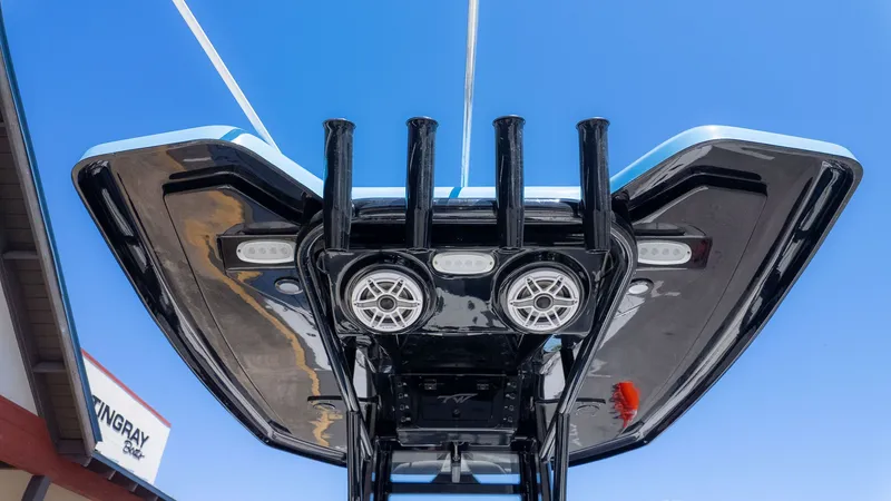 Slide: The Image of Underneath view of a boat's T-top with speakers and lights, against a blue sky. - 20