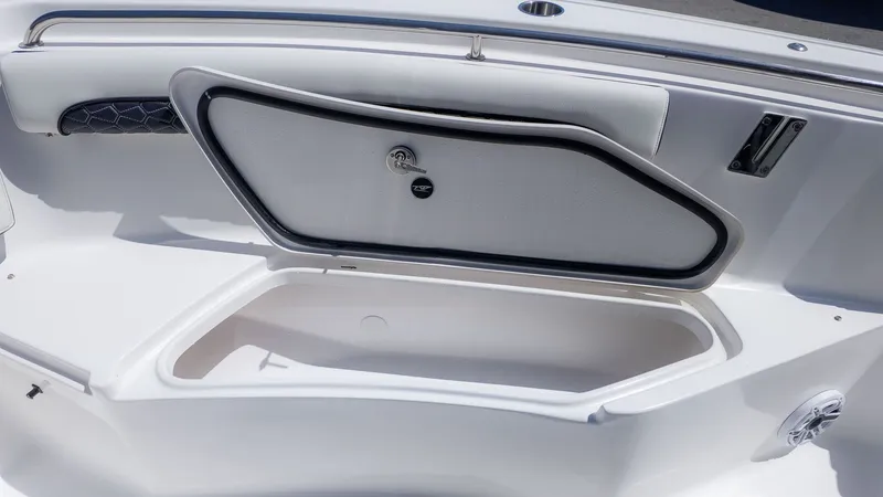 Slide: The Image of An open storage compartment on a boat with a padded lid and speaker. - 13