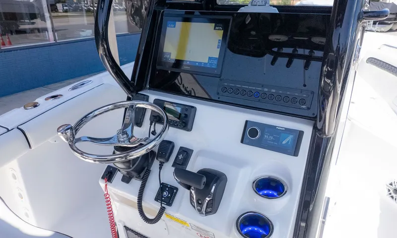 Slide: The Image of The image shows the helm of a Tidewater 232 LXF boat with modern navigation equipment. - 16