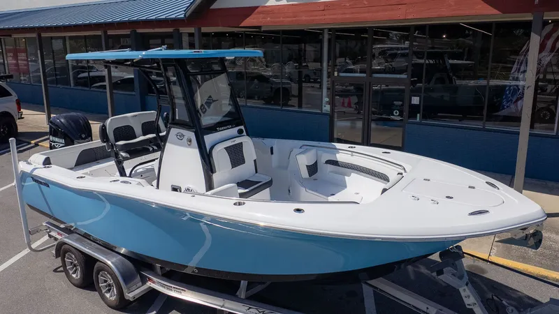 Slide: The Image of A modern Tidewater 232 LXF boat on a trailer, featuring a blue hull and spacious deck. - 21
