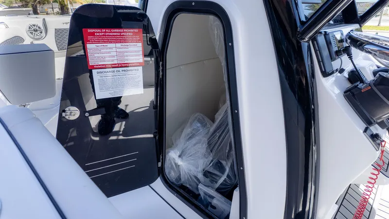 Slide: The Image of The 2026 Tidewater 232 LXF features a cabin door with warning labels and a glimpse inside. - 9